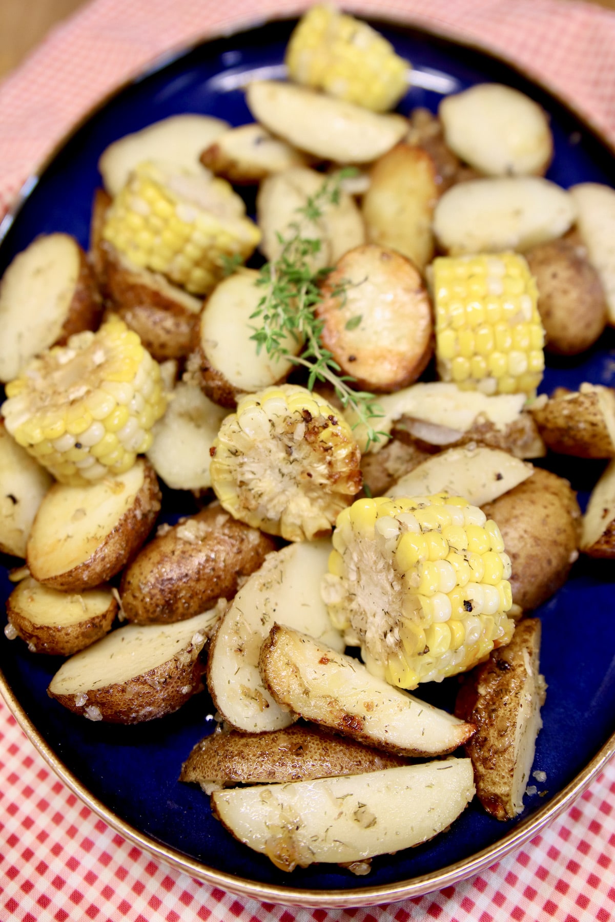 Platter with potatoes and corn cob slices.