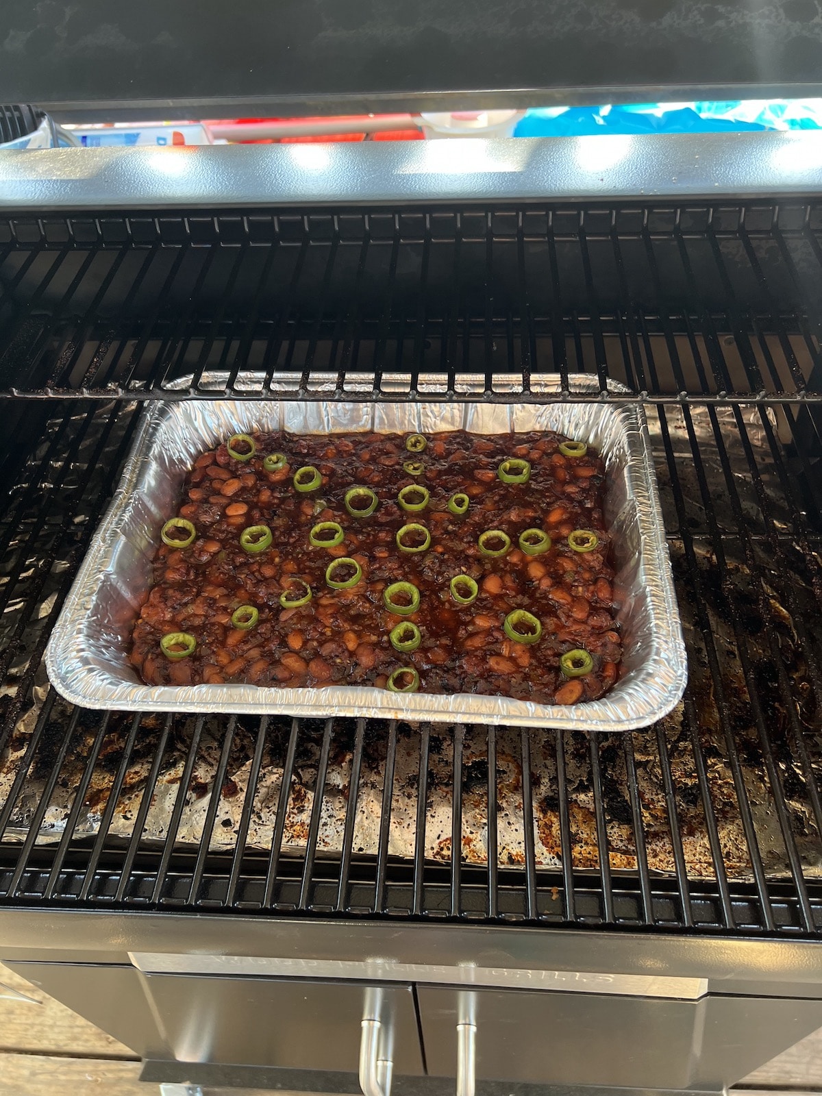 Cowboy beans cooking on grill.