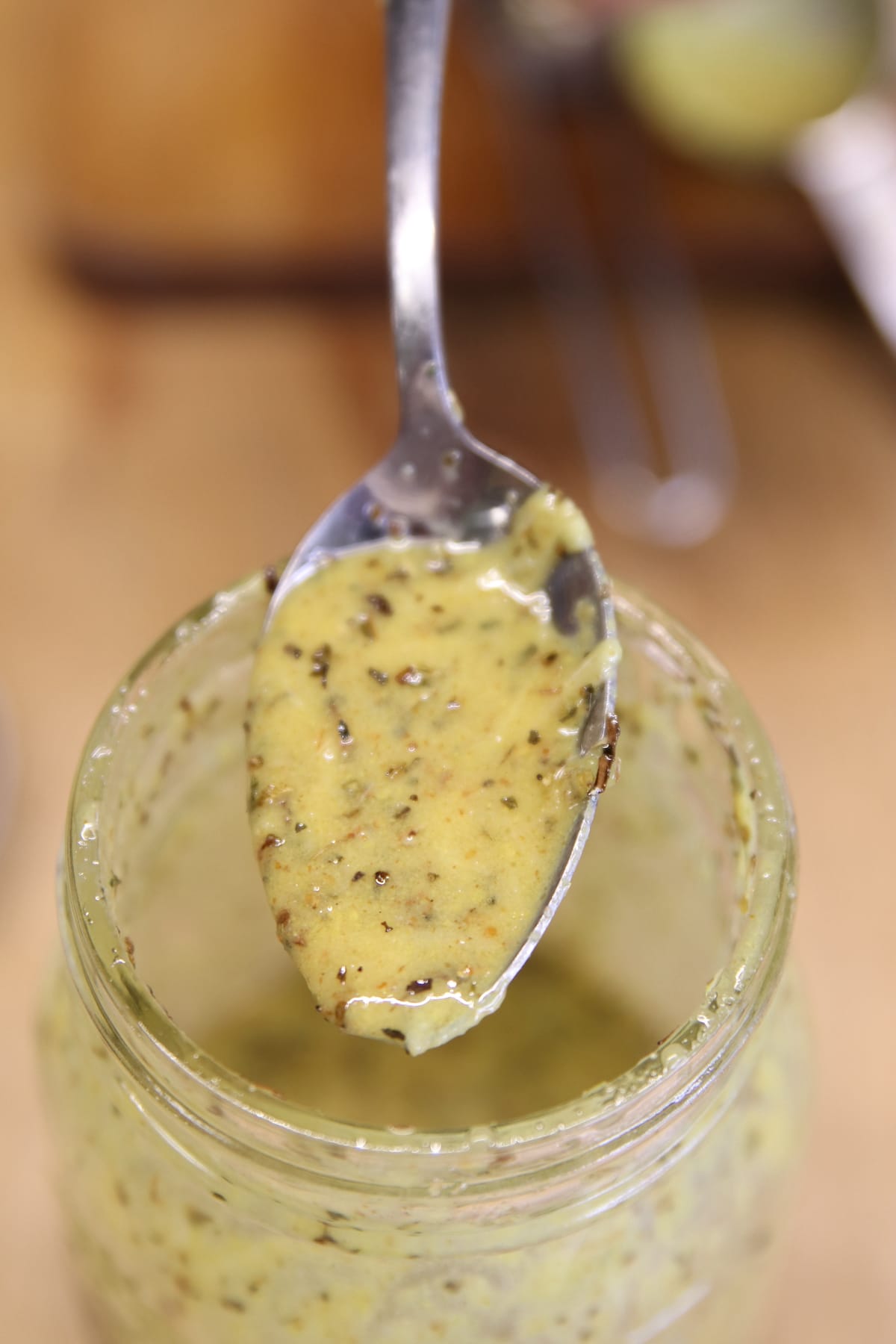 Italian Dressing with mustard on a spoon.