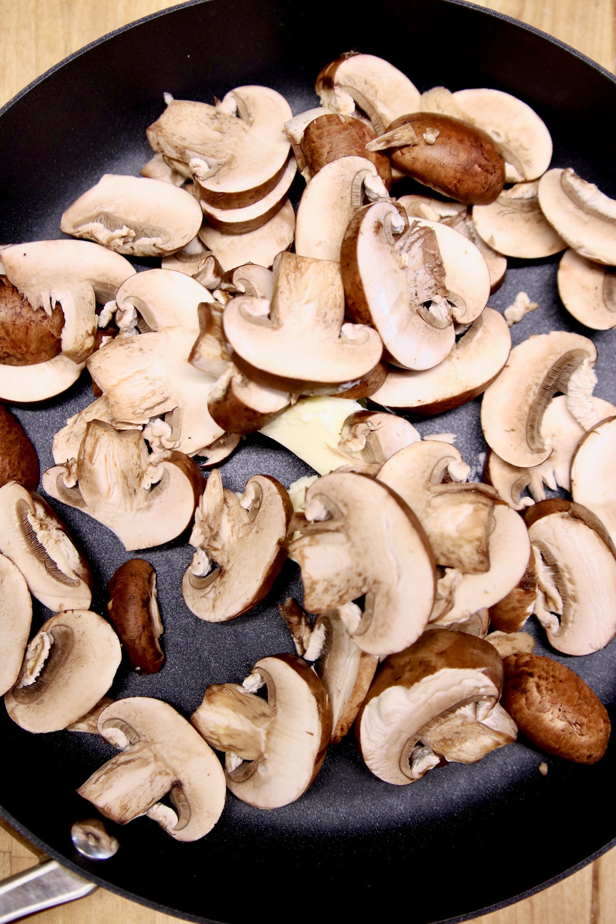 Sliced mushrooms in a skillet.