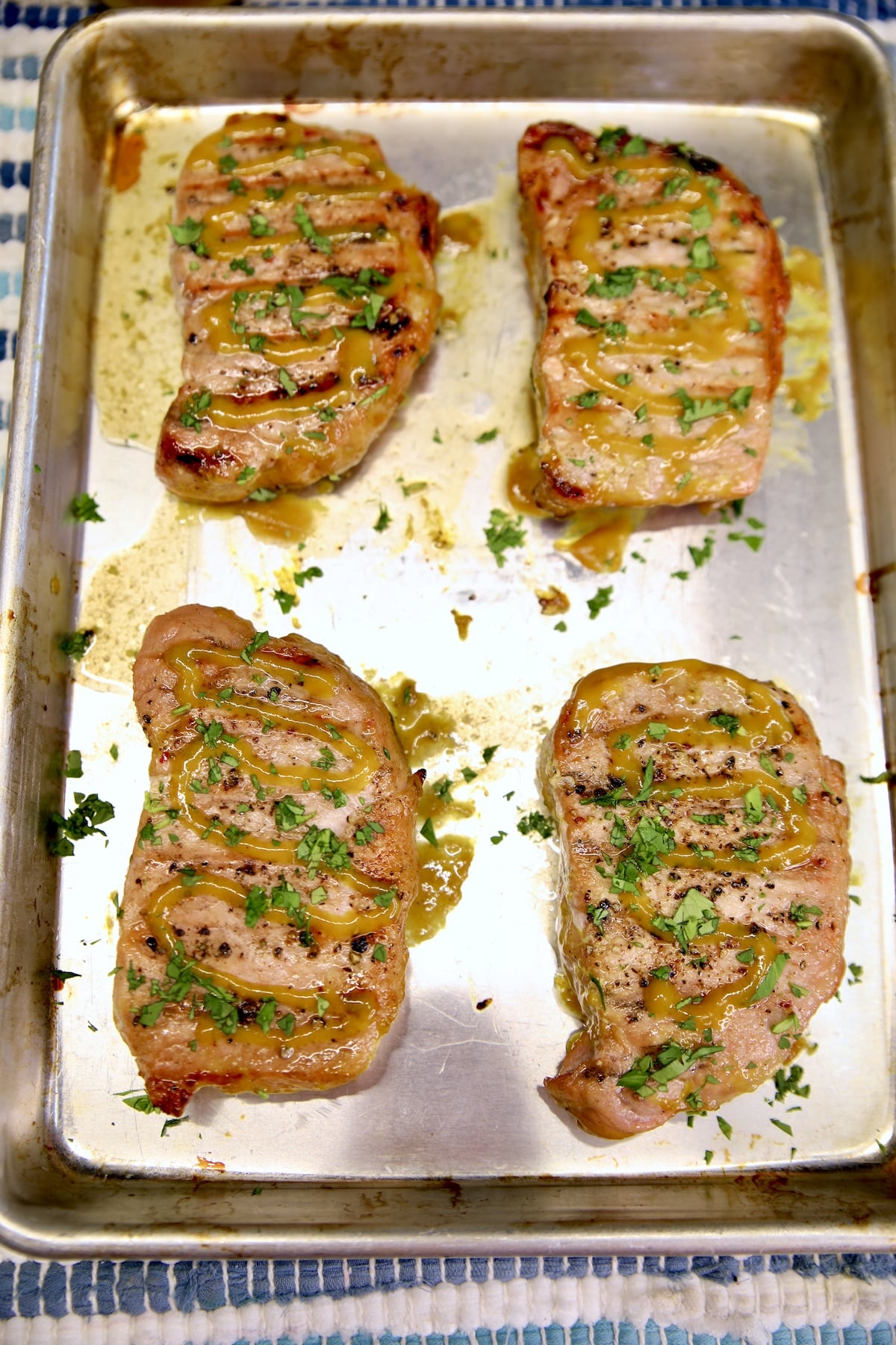 4 Grilled Mustard pork chops on a sheet pan.
