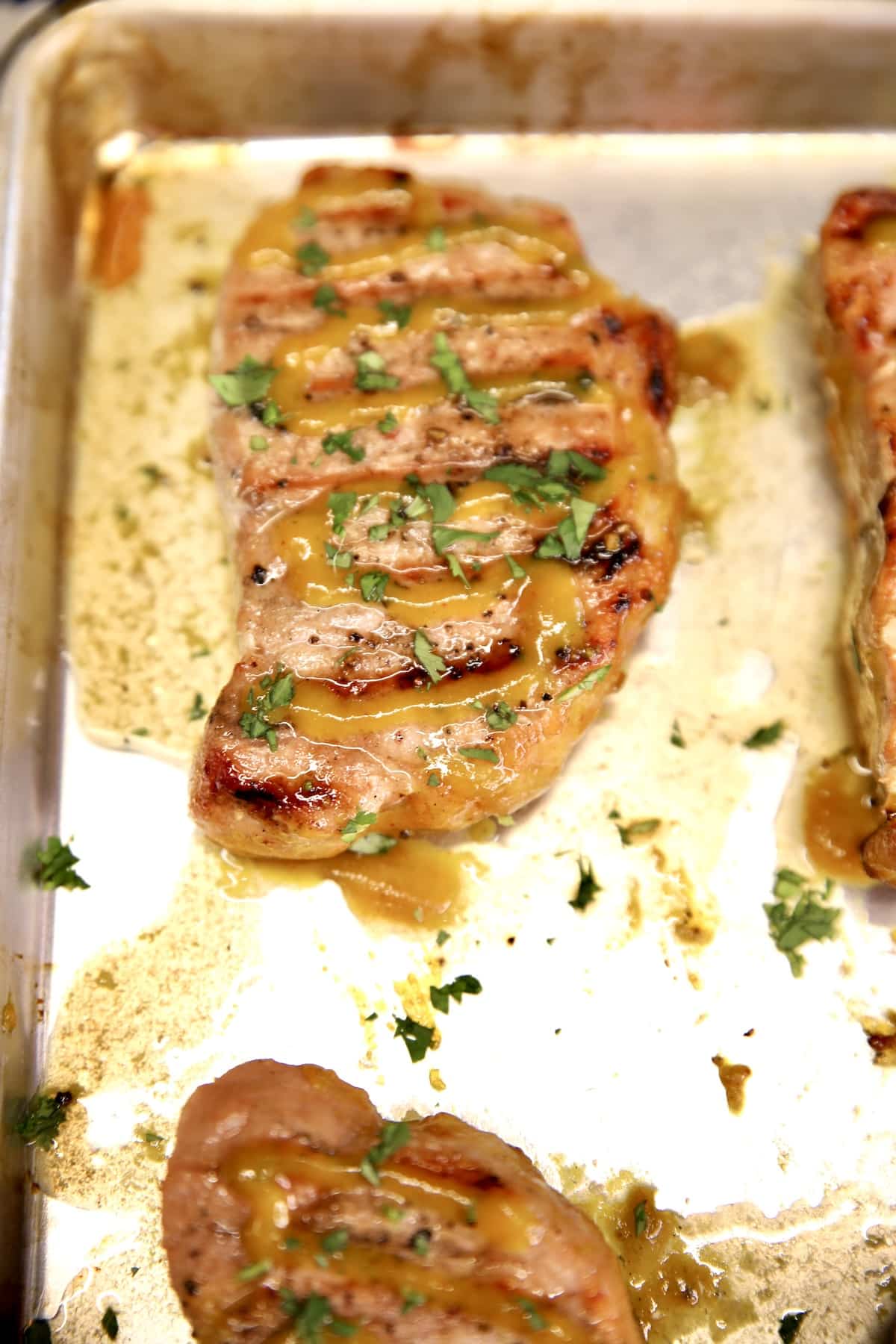 Grilled pork chop with mustard glaze.