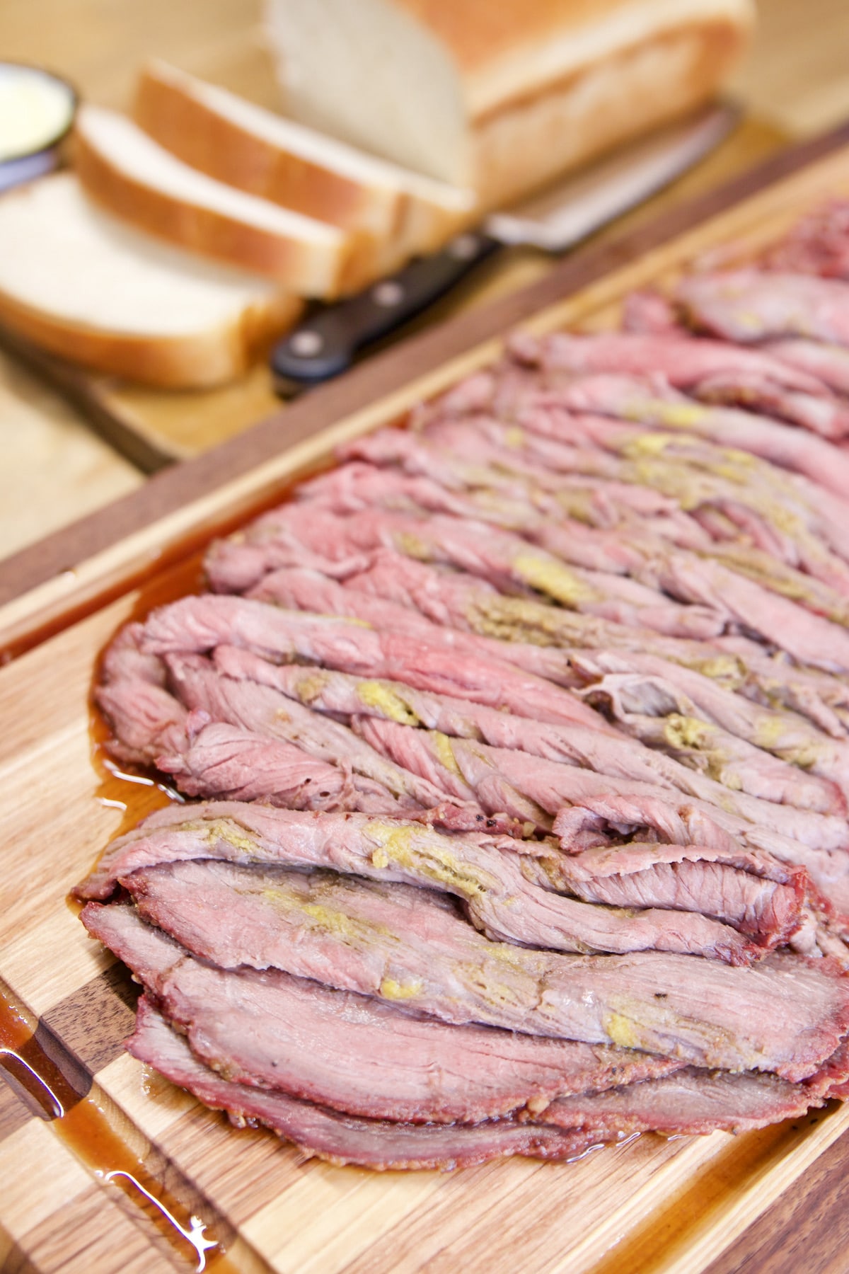Roast beef sliced on a cutting board.