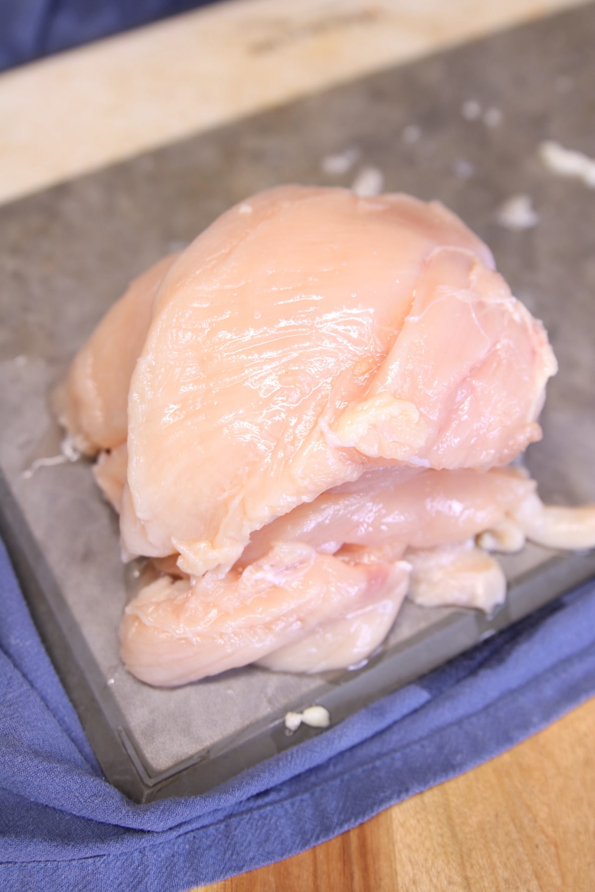 Sliced chicken breasts on a cutting board.