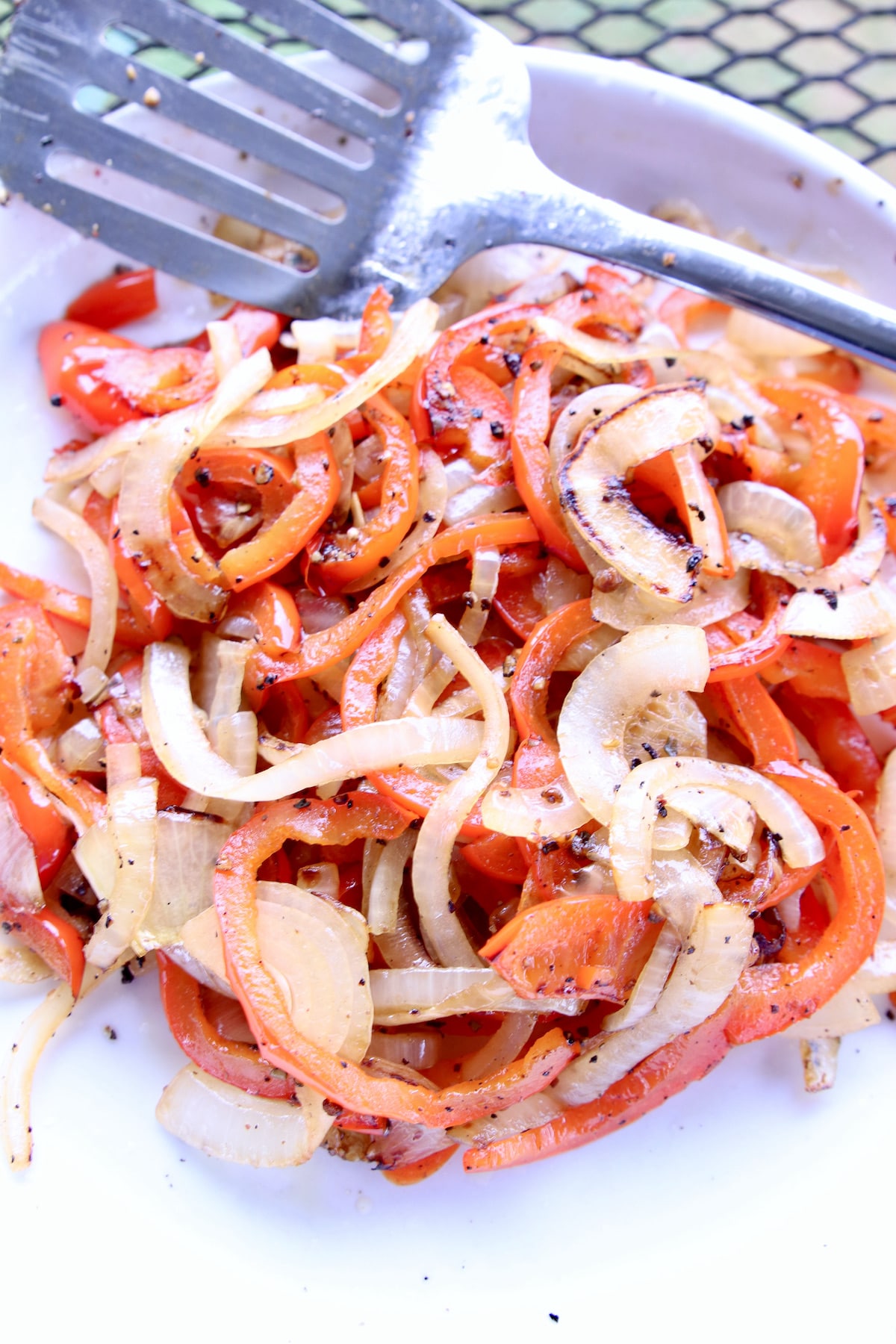 plate of grilled peppers and onions.