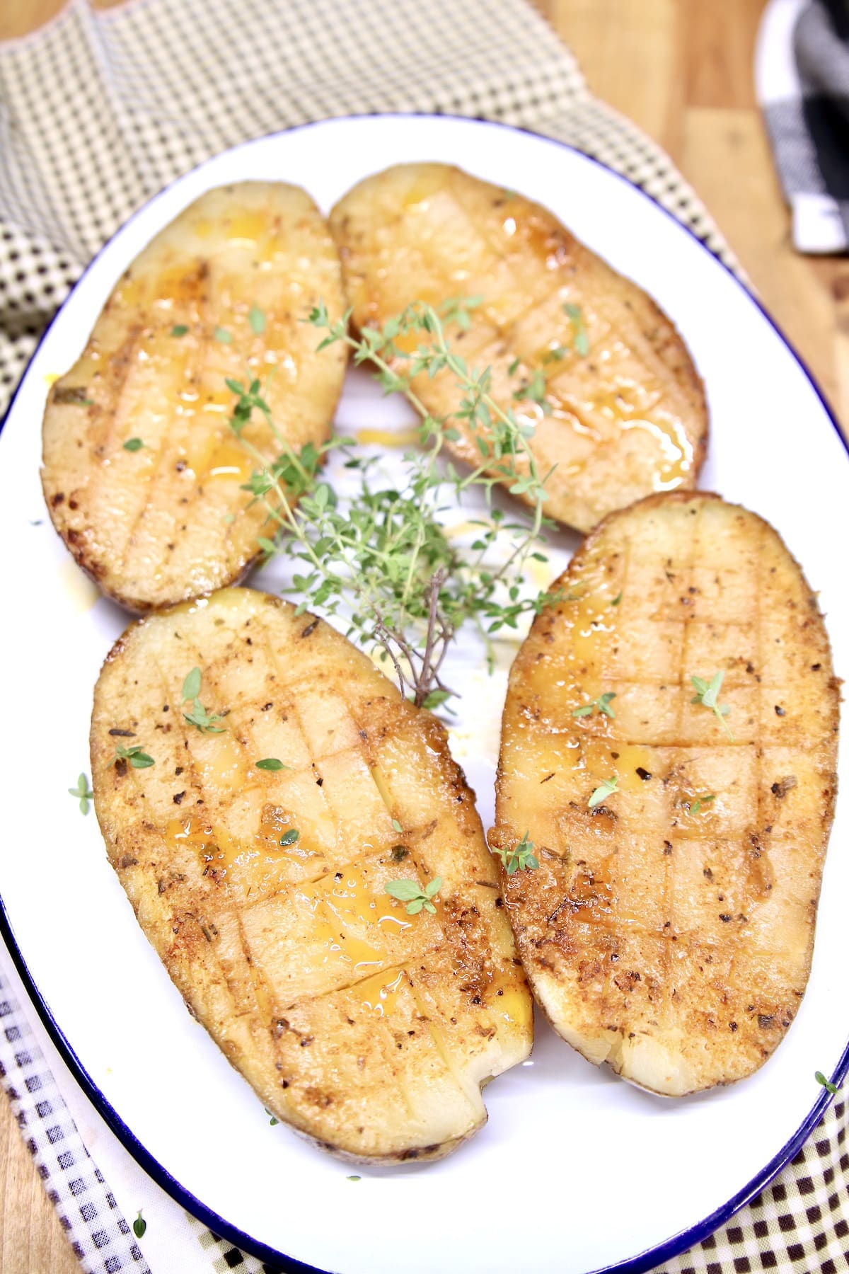 Creole butter baked potatoes on a platter.
