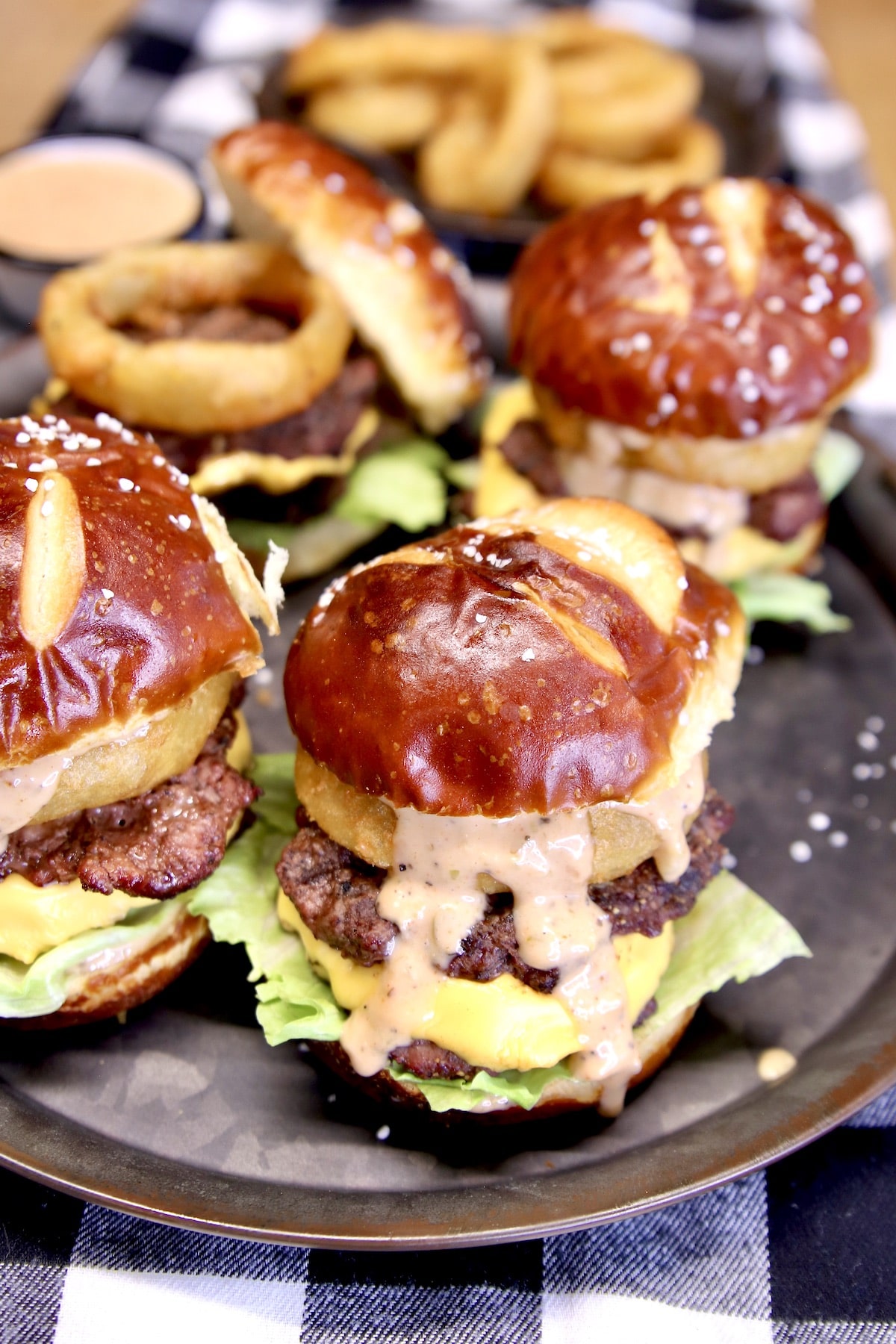 Tray of pretzel bun burger sliders.