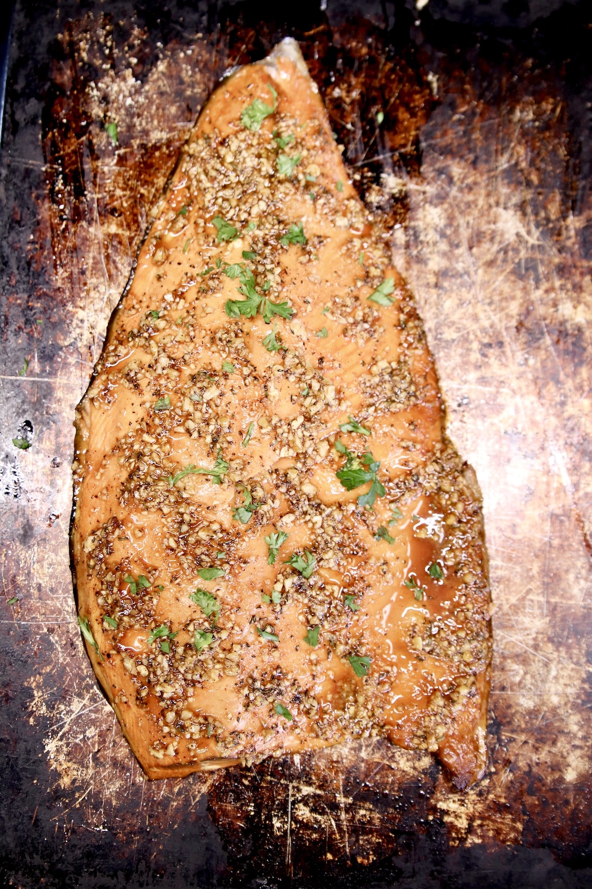 Grilled salmon filet on a sheet pan.