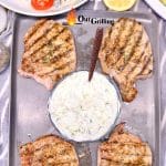 Text overlay - grilled pork chops on a platter with tzatziki sauce.
