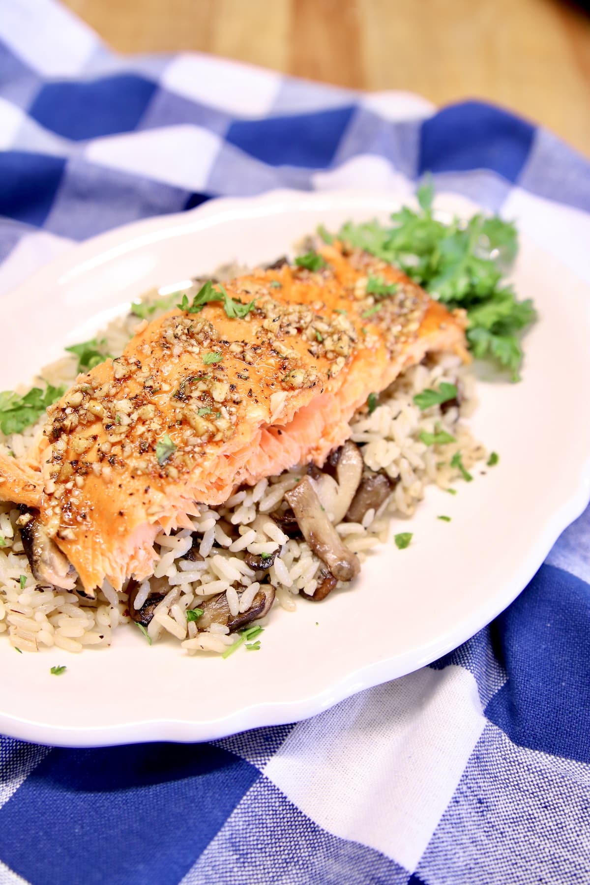 Plate with rice pilaf and honey pecan salmon filet.