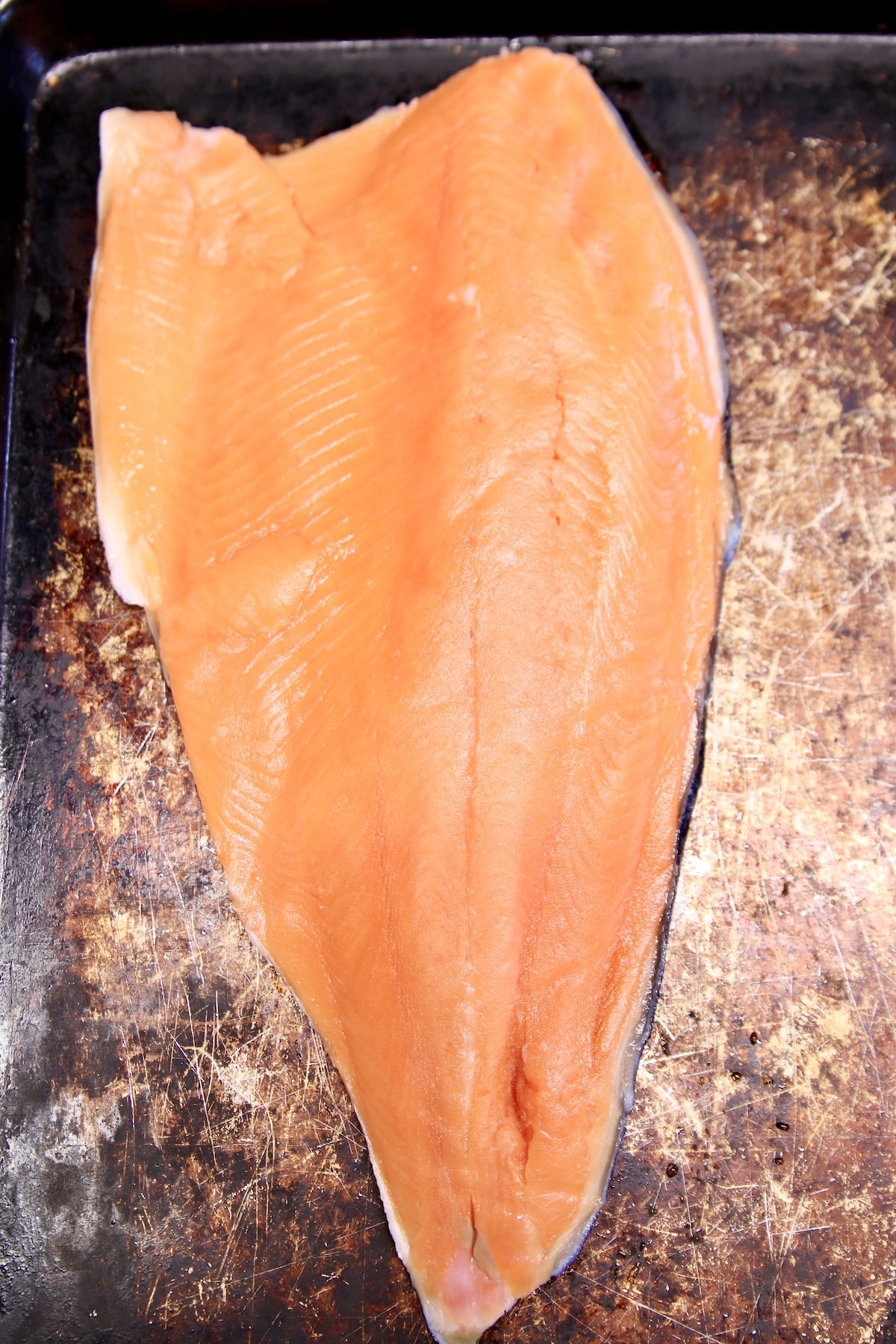 Salmon filet on a baking sheet.
