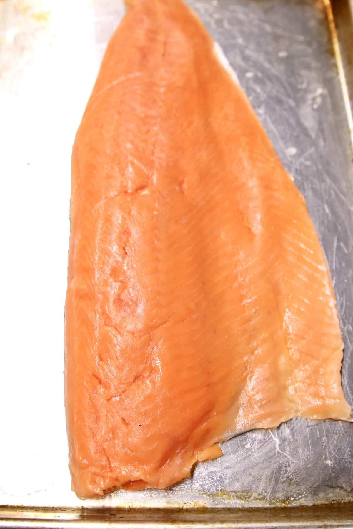 Salmon fillet on a baking sheet.