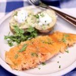 Salmon fillet on a plate with baked potato.