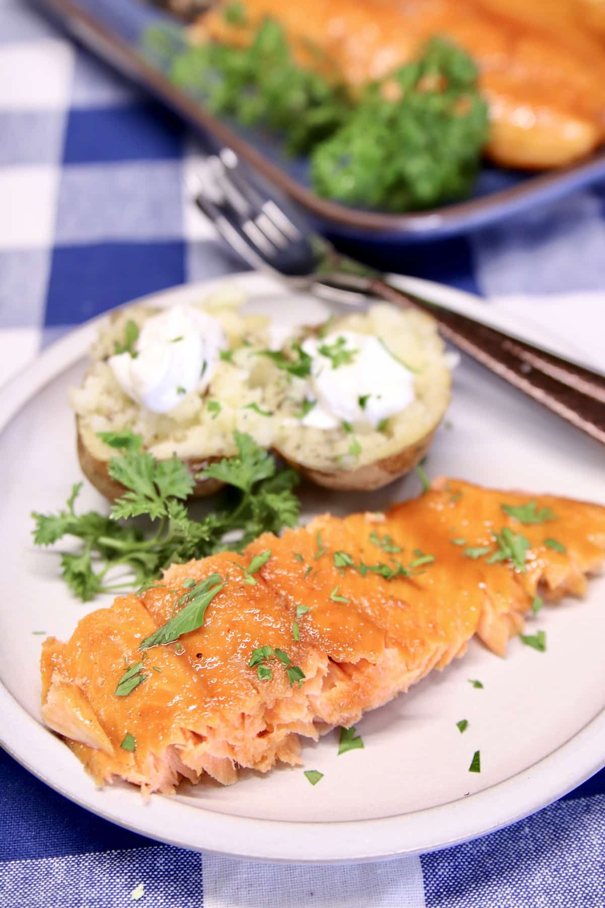 Plated salmon fillet with baked potato.