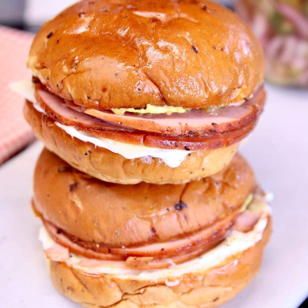 2 smoked bologna sandwiches on onion buns, stacked.