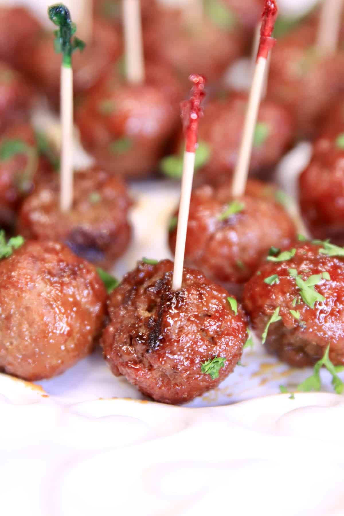 Meatballs with appetizer picks on a platter.