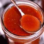 Root Beer BBQ Sauce in a jar with spoon. Text overlay.