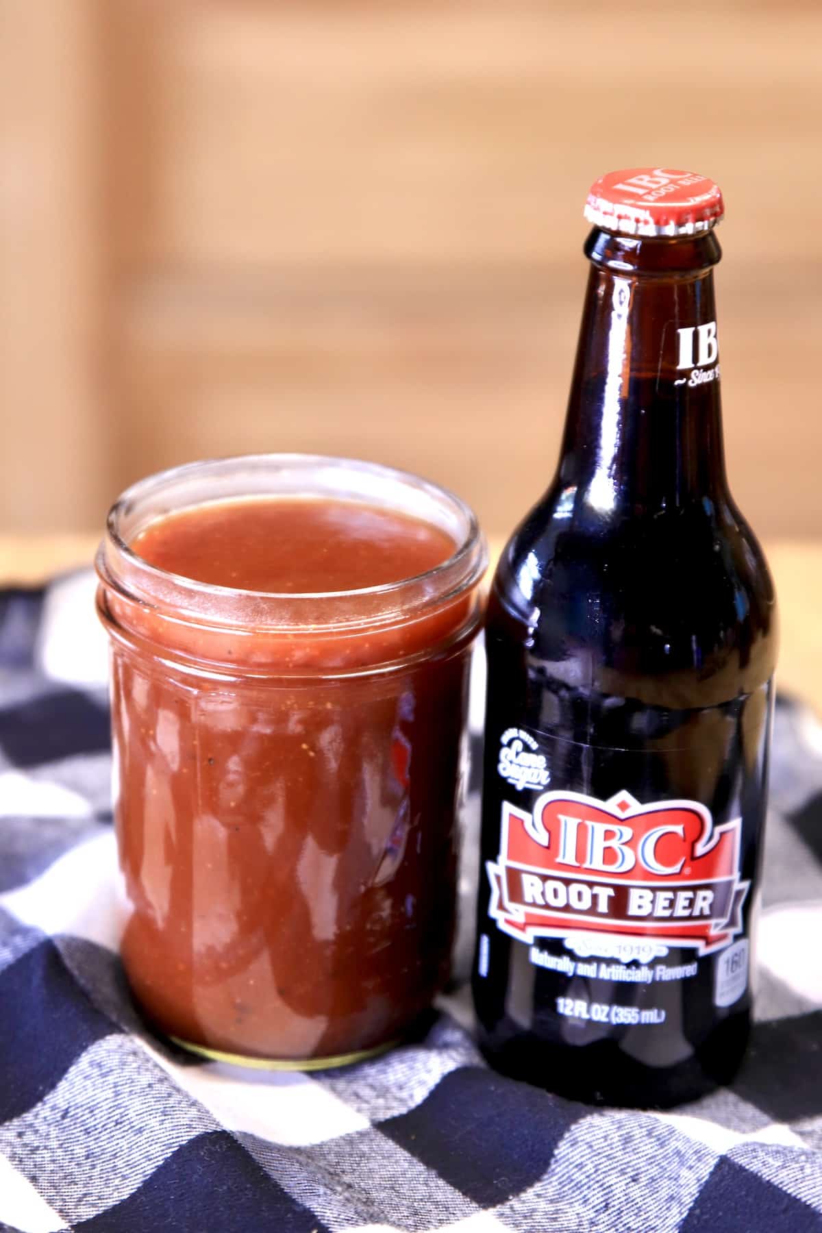 Jar of BBQ Sauce with Root Beer bottle.