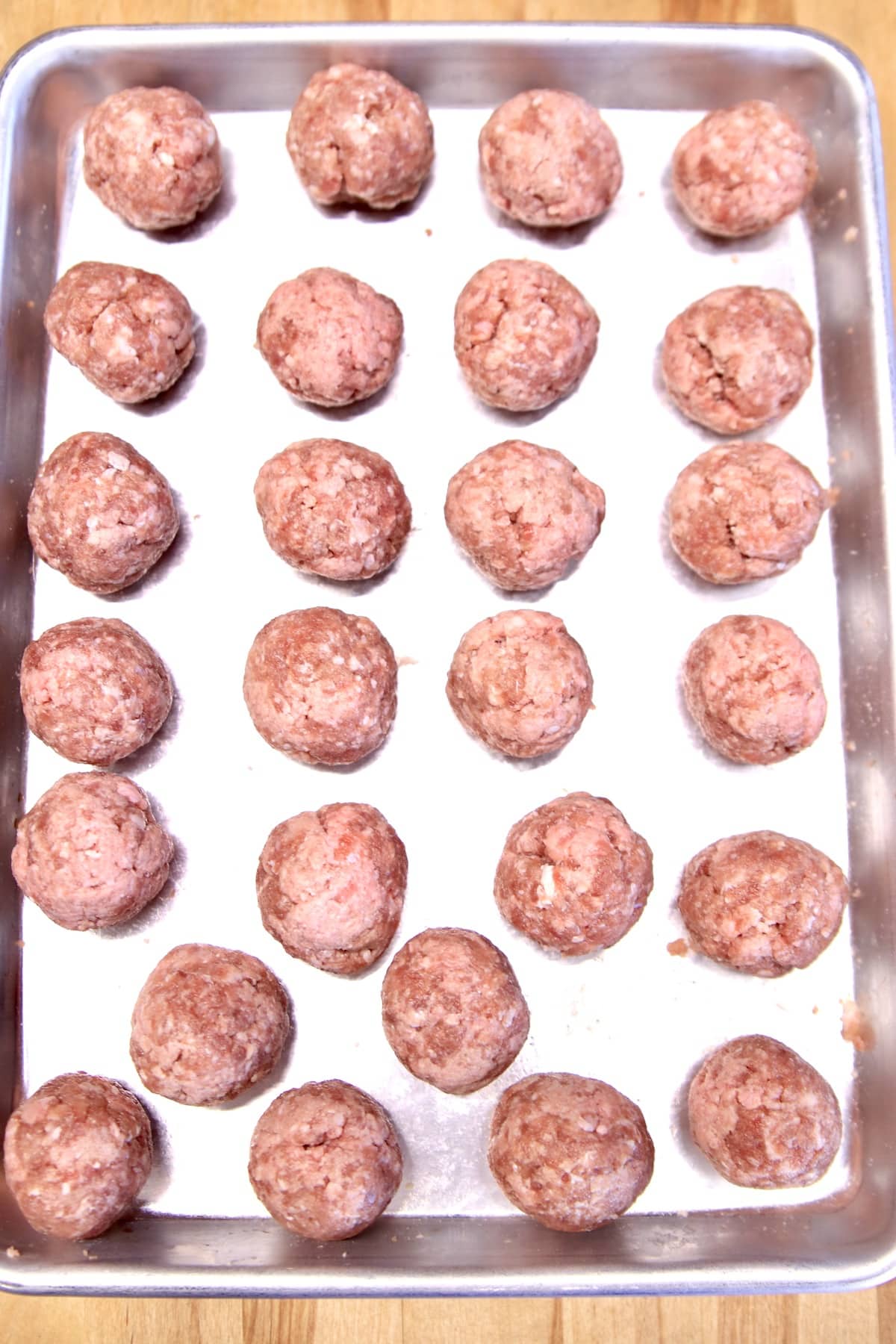 Venison Meatballs on a baking sheet ready to grill.