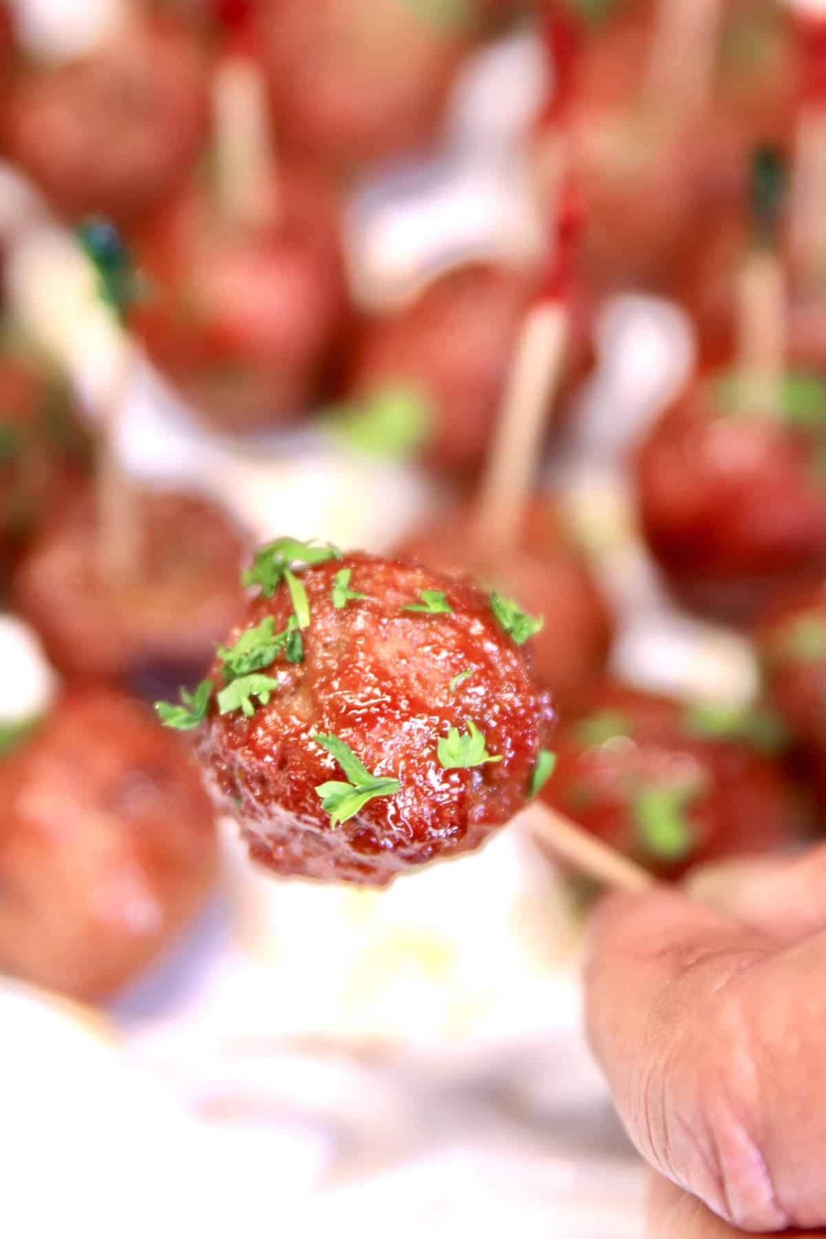 Closeup of meatball on an appetizer pick.