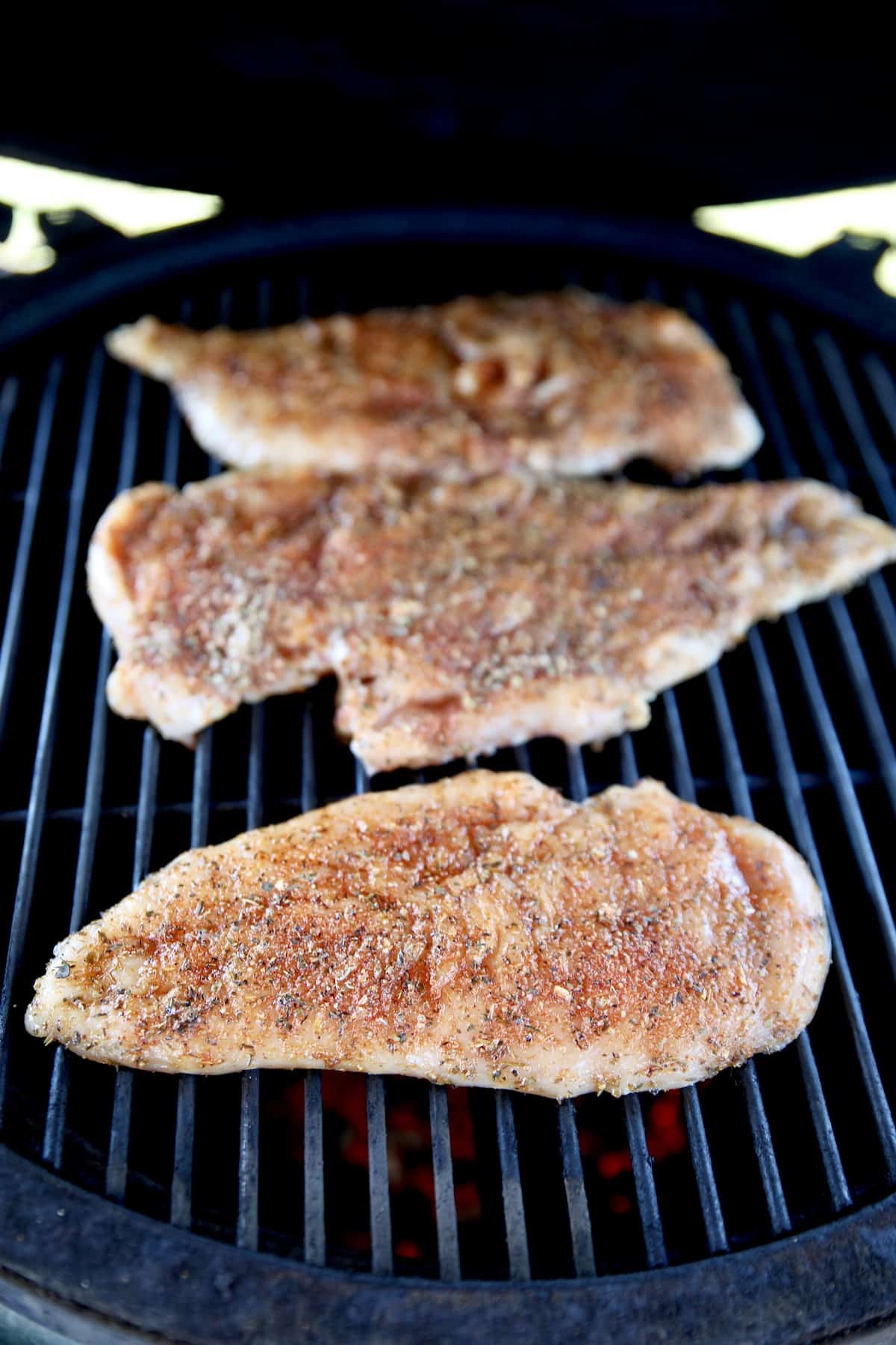 Chicken cutlets on a grill.