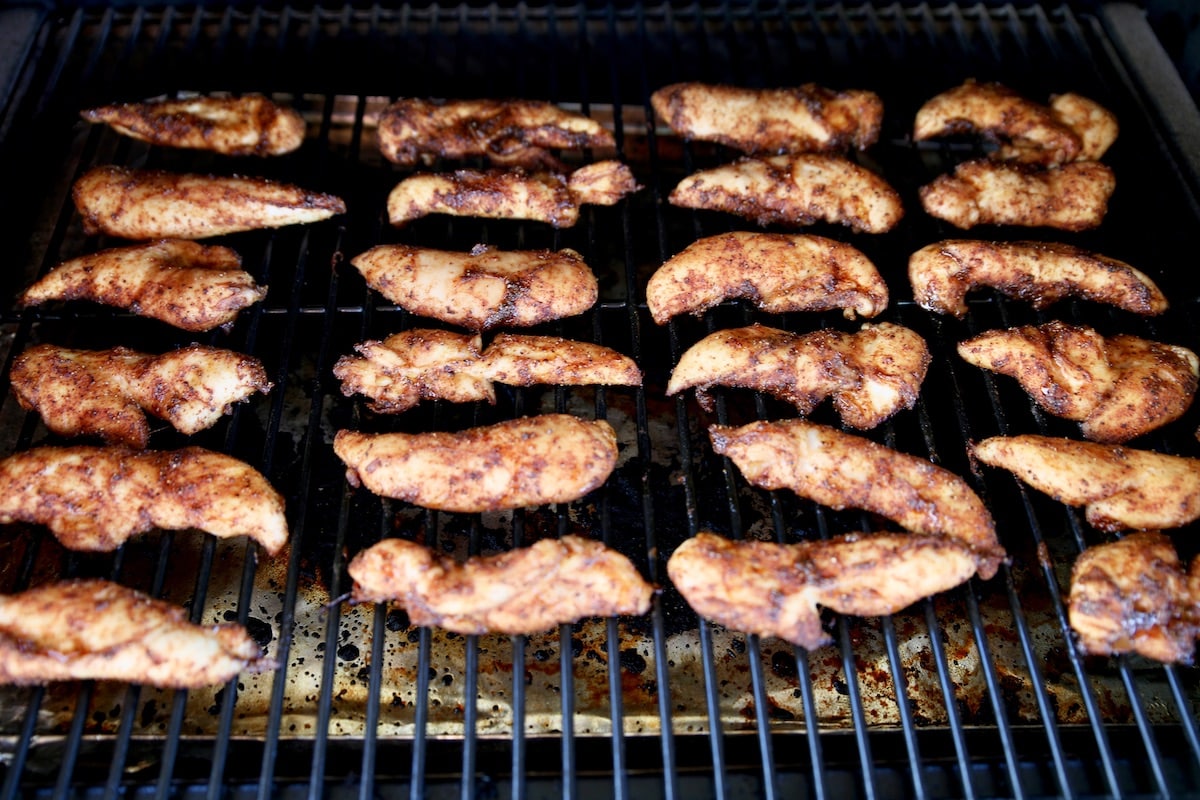 Fajita seasoned chicken tenders on a grill.