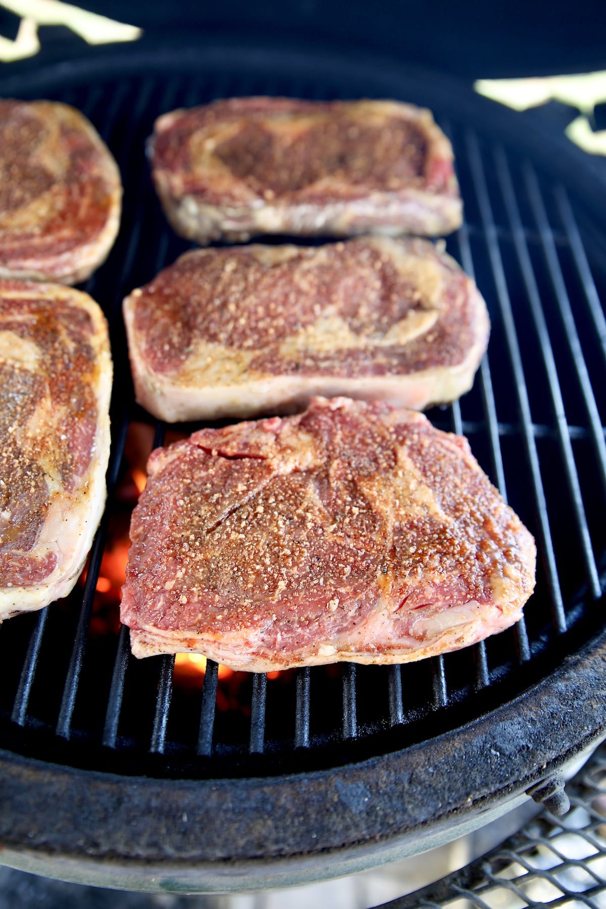Grilling ribeye steaks.