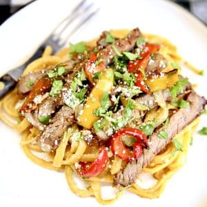 Closeup of plate of pasta with steak fajitas.
