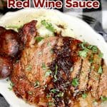 Grilled steak with red wine sauce. Plated with potatoes and mushrooms.