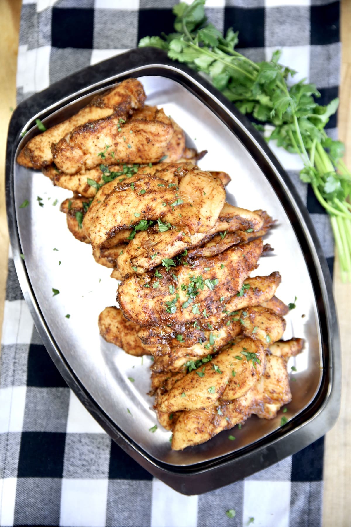 Platter of chicken tenders with cilantro.