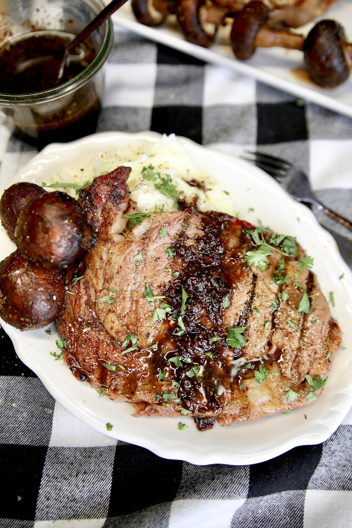 Plate of grilled steak with red wine sauce.