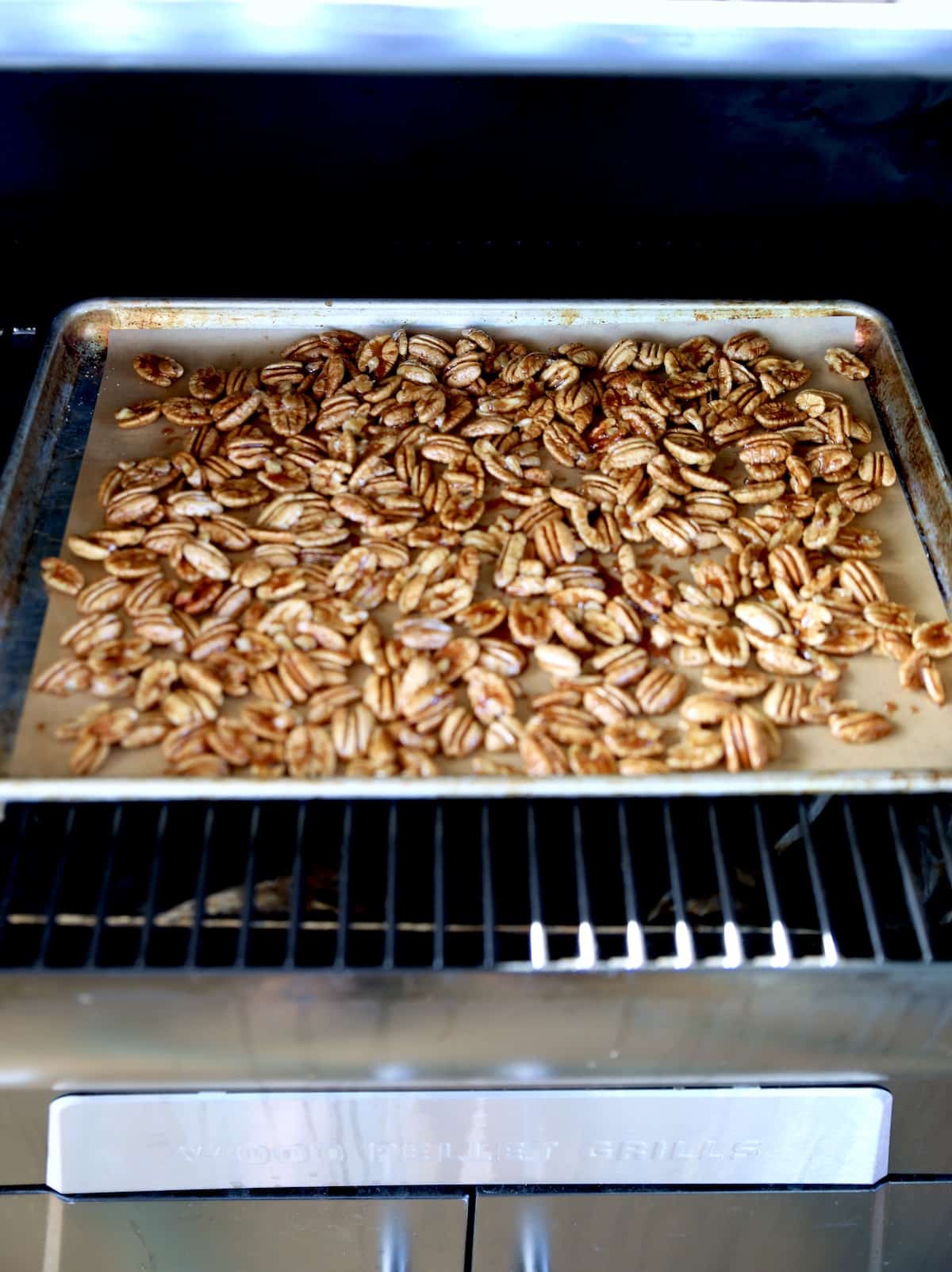 Cooking a sheet of pecans on pellet grill.