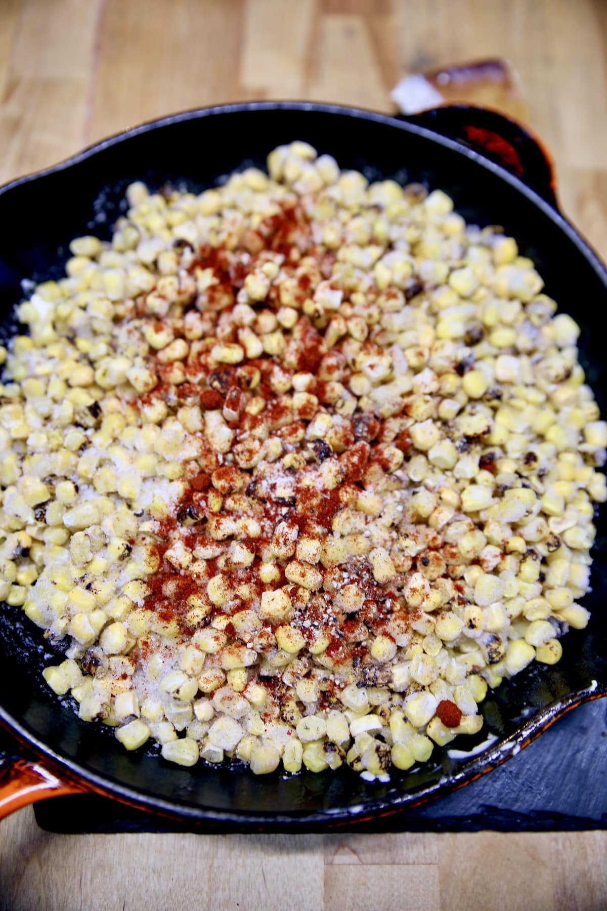 Corn in a skillet with spices.