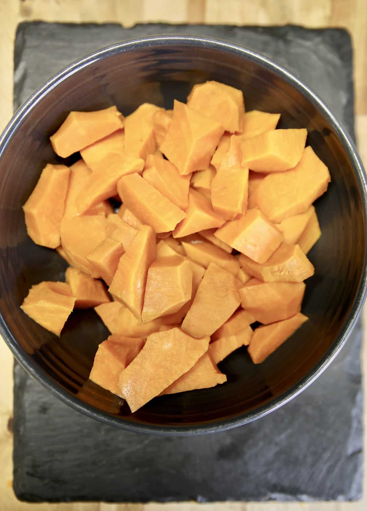 Bowl of diced sweet potatoes.