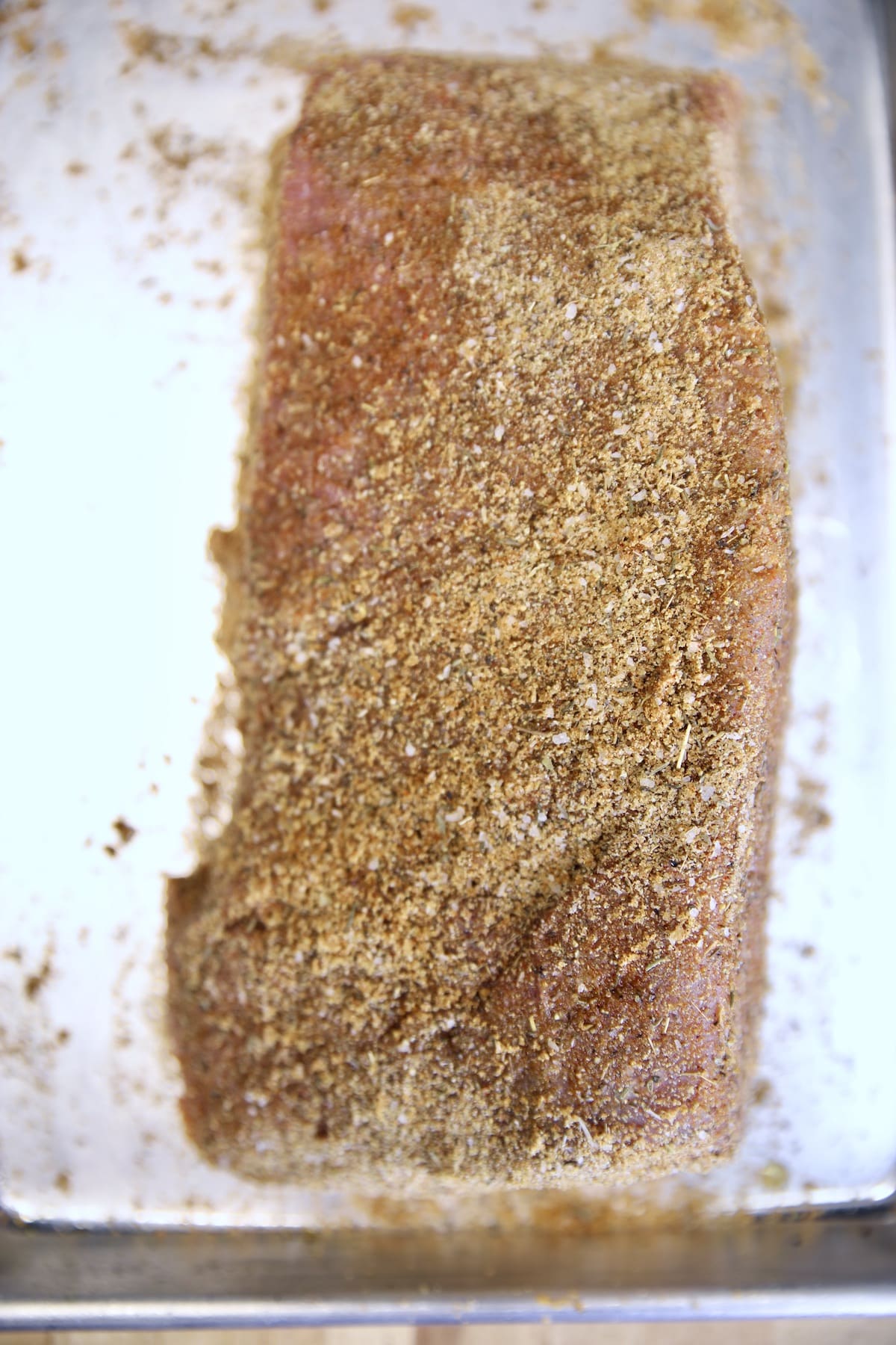 Top round roast with dry rub seasoning ready to grill.