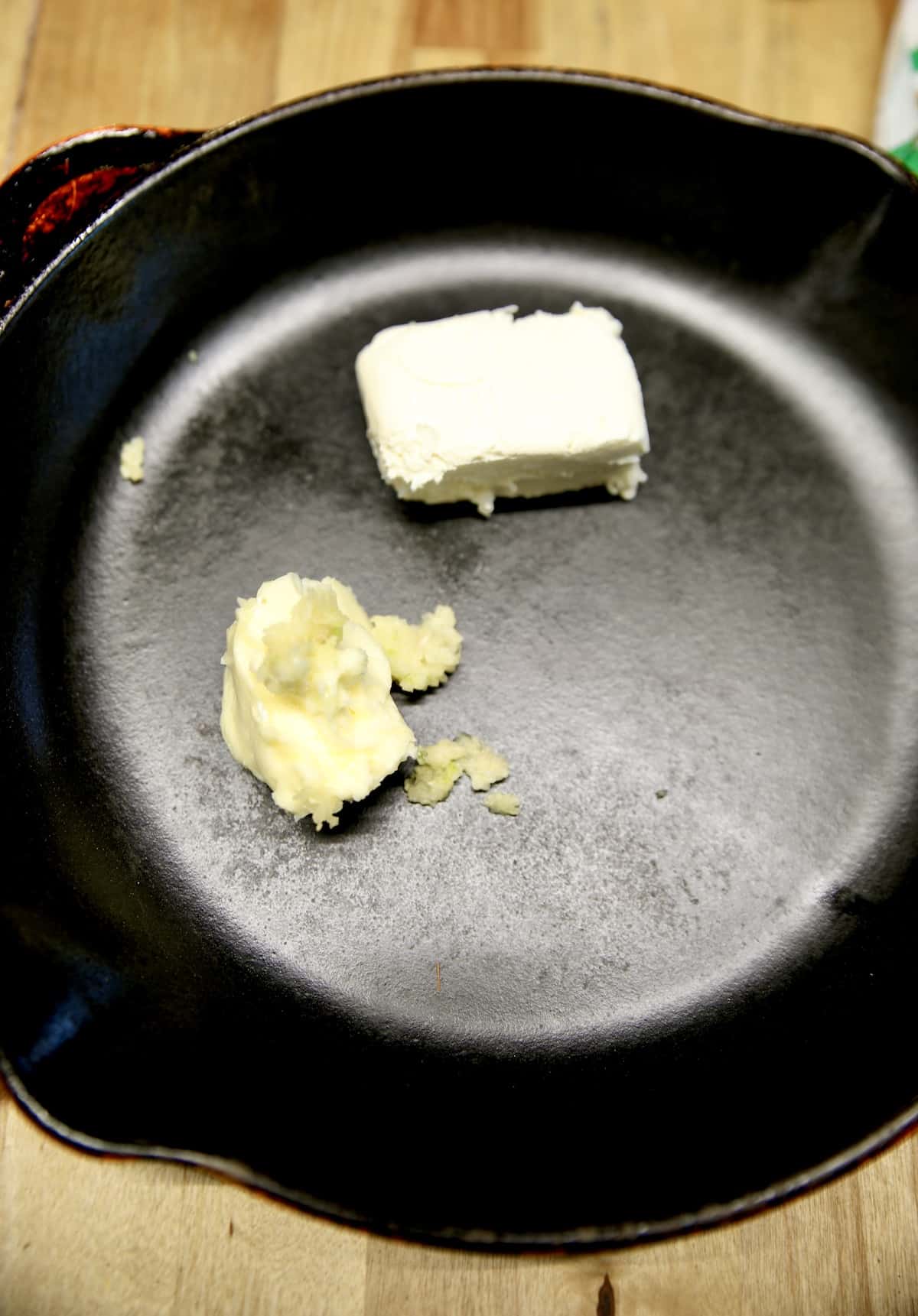 Butter, garlic and cream cheese in a skillet.