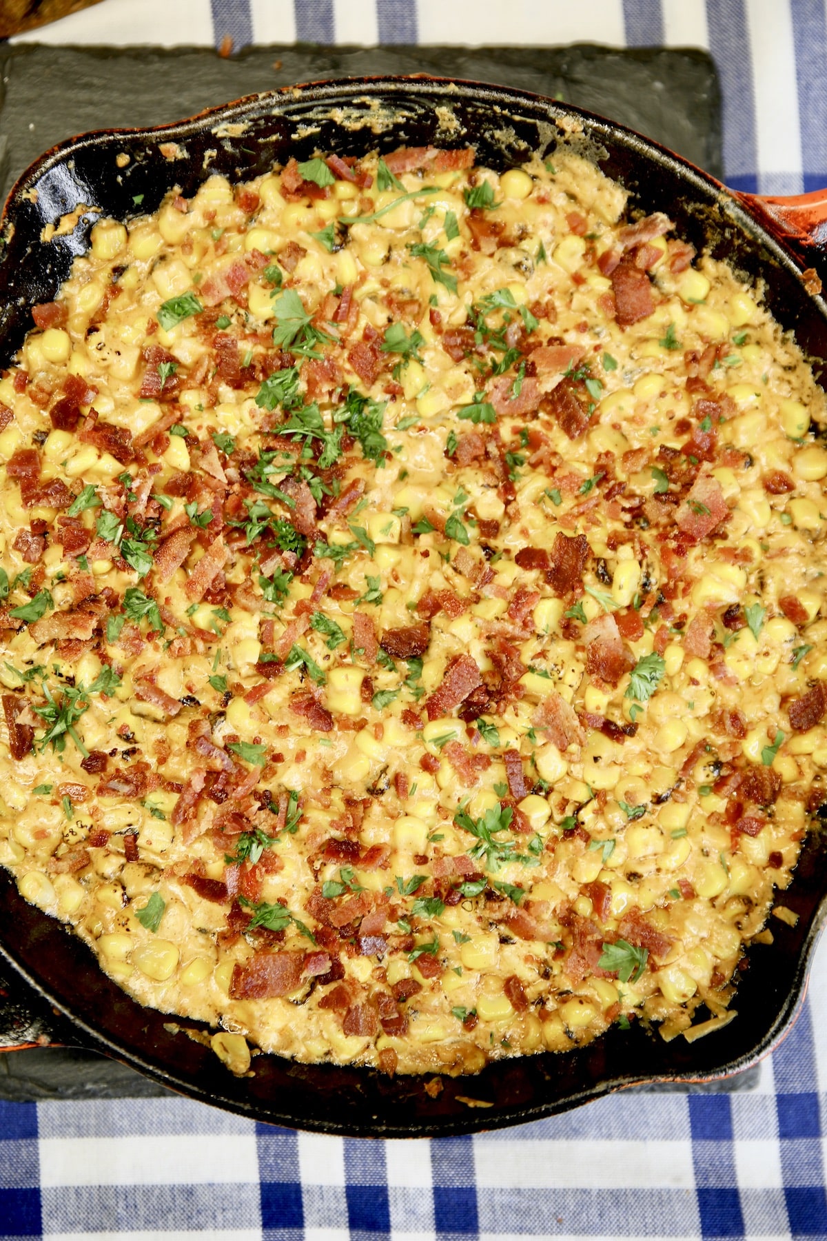 Closeup of skillet of creamed corn with bacon.