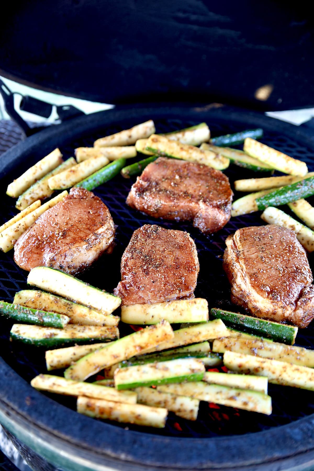 Grilling pork chops and zucchini wedges.