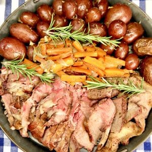 Platter of sliced roast beef and vegetables.