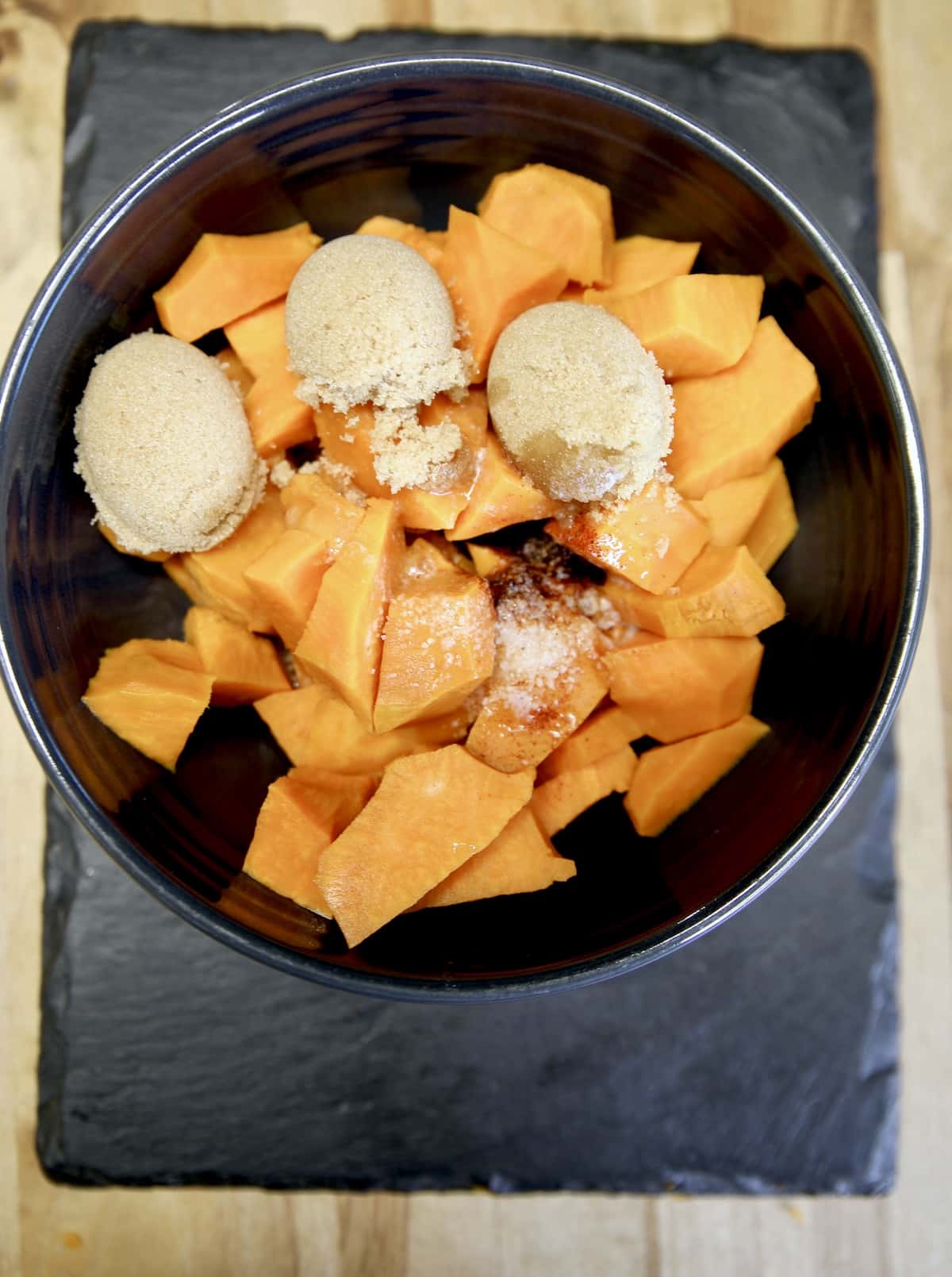 Bowl of chopped sweet potatoes with brown sugar & butter.