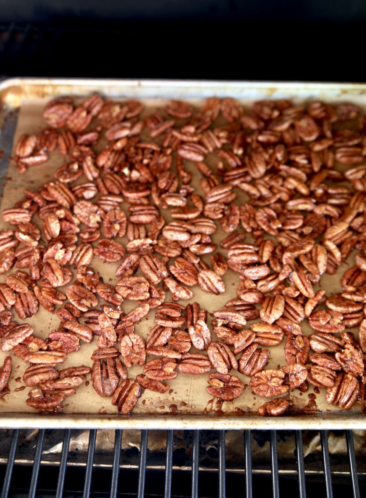 Candied pecans cooking on a pellet grill.