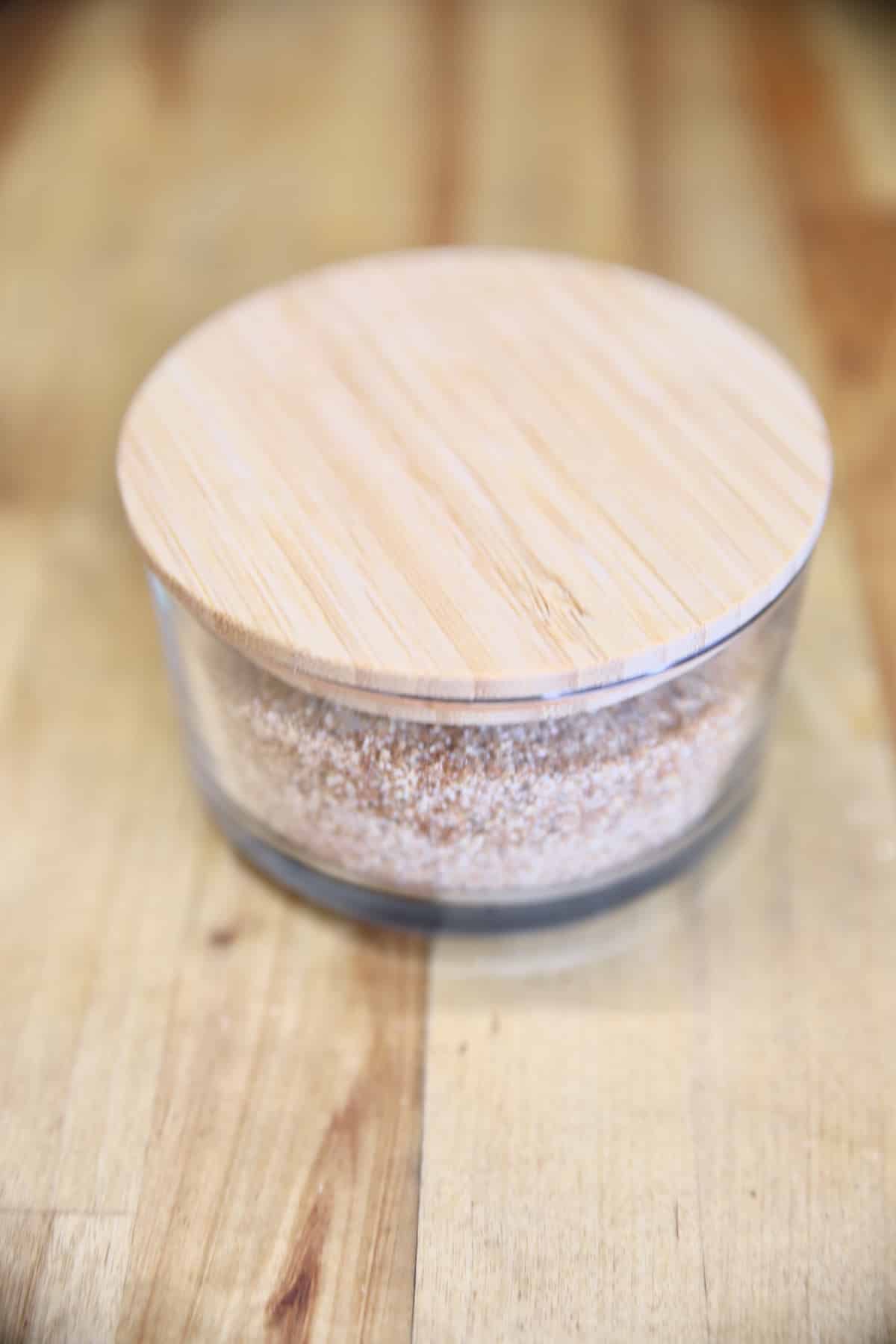 Chili seasoning in a bowl with wooden lid.
