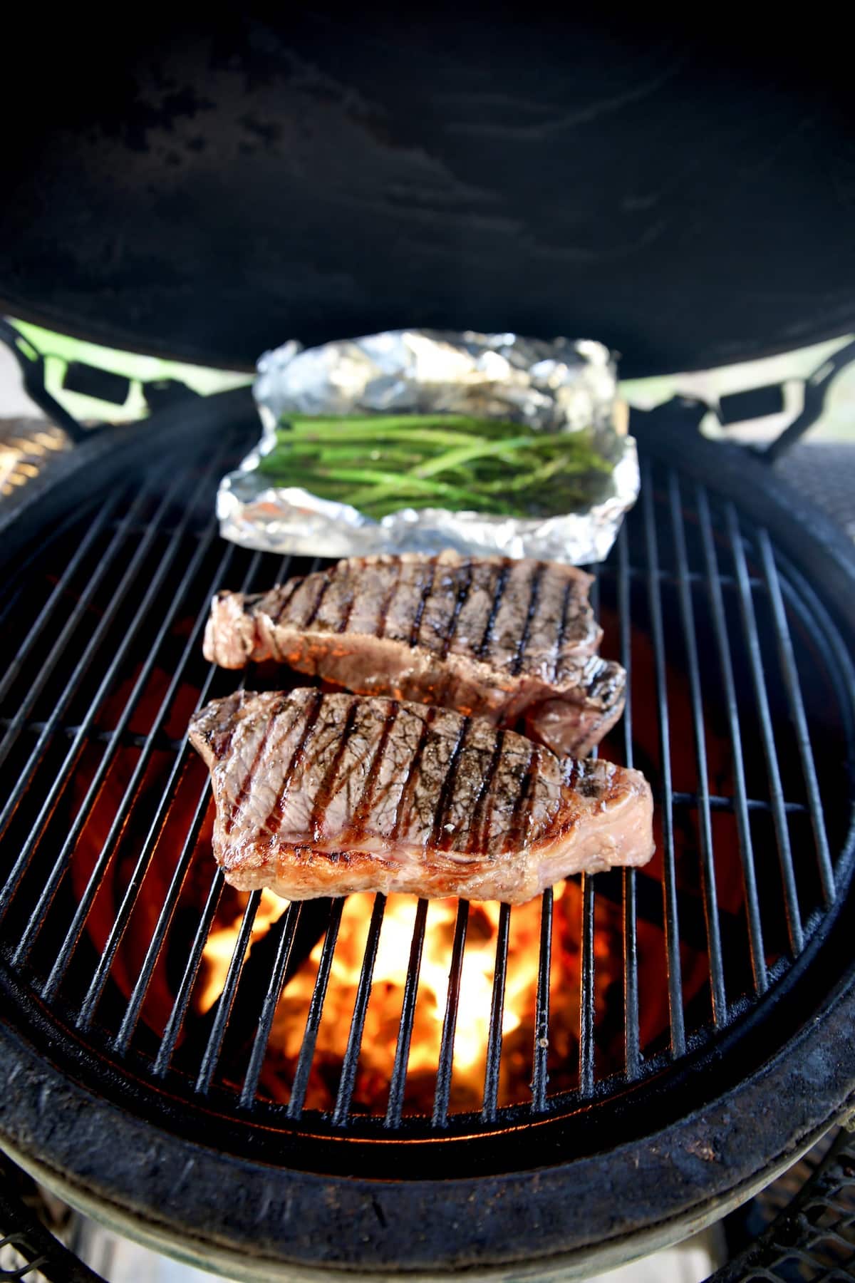 Grilling NY Strip steaks and asparagus.