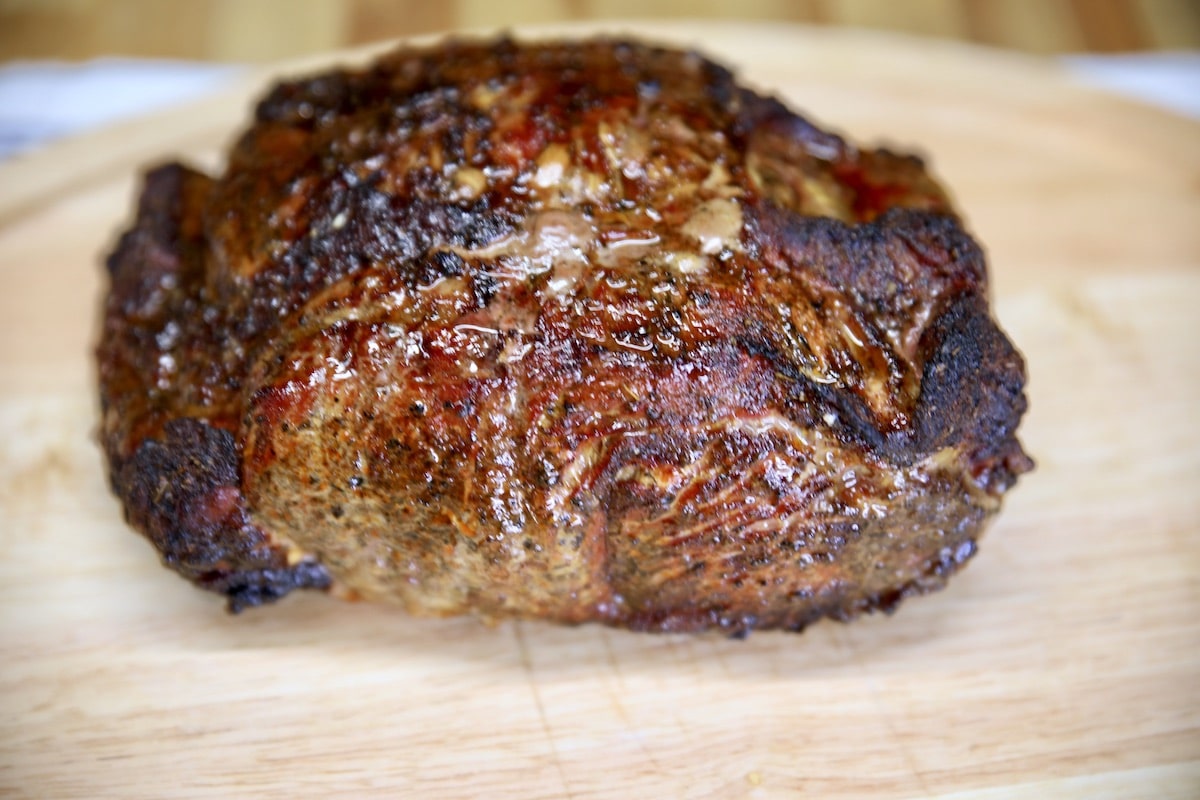 Grilled NY Strip Roast resting on cutting board.