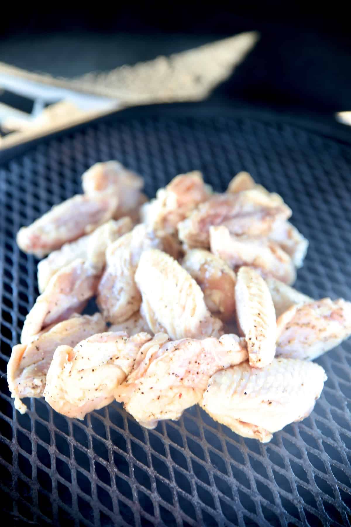 Chicken wings on a grill.