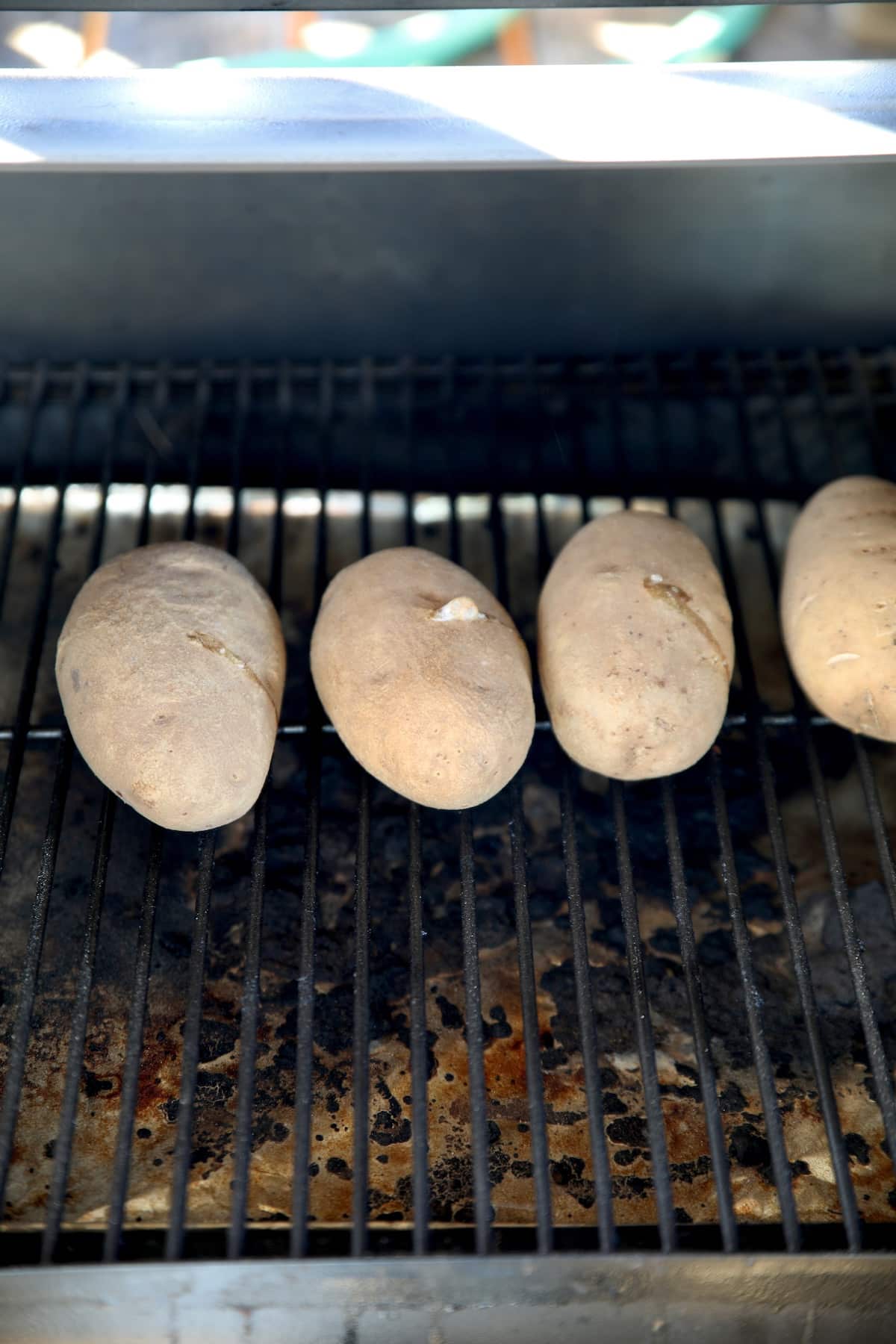 4 baking potatoes on a pellet grill.