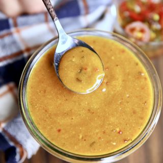 Spoon of sweet and spicy mustard.