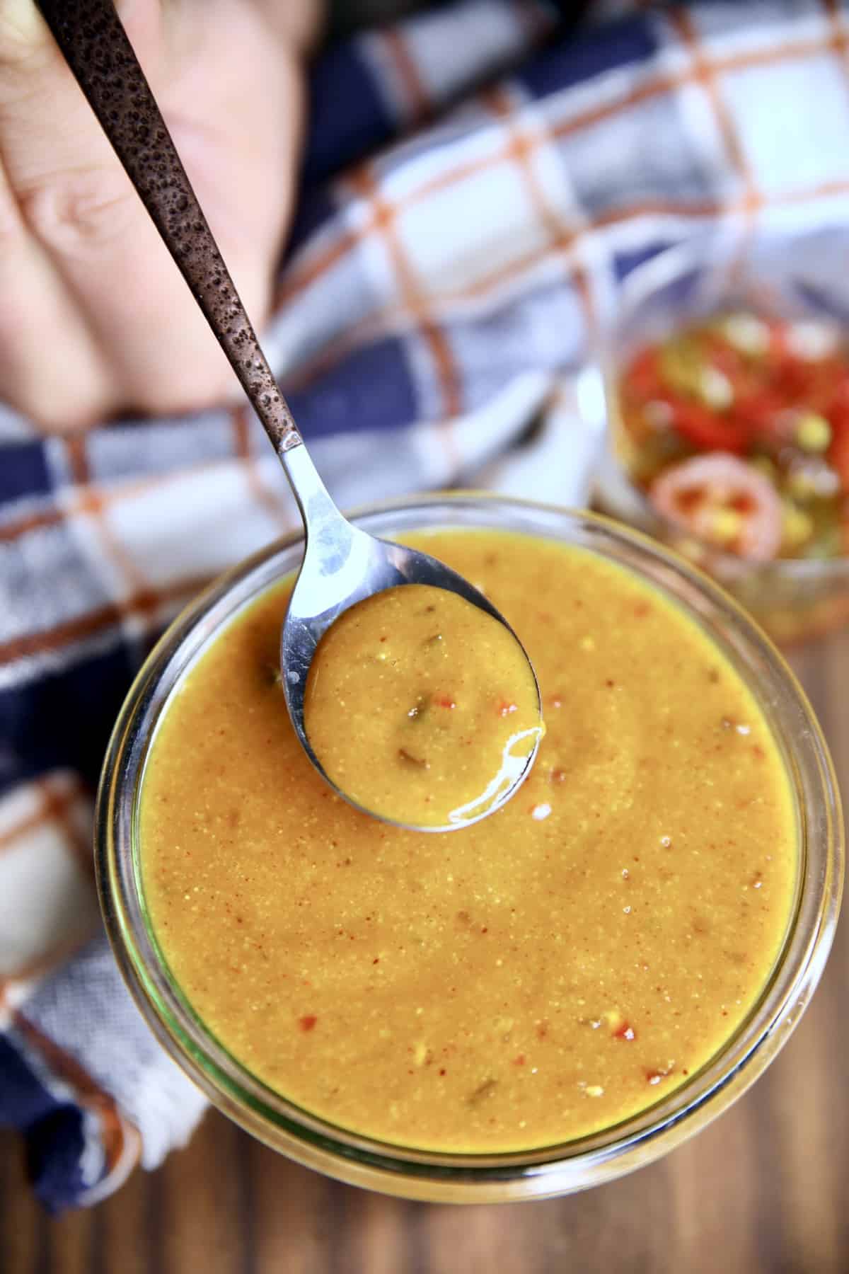 Bowl with a spoonful of mustard sauce.
