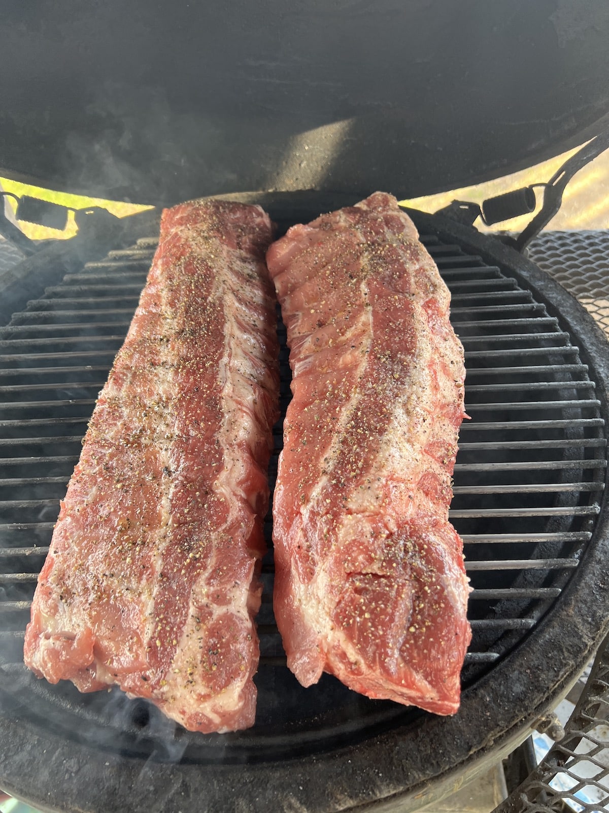 2 racks ribs on a grill.