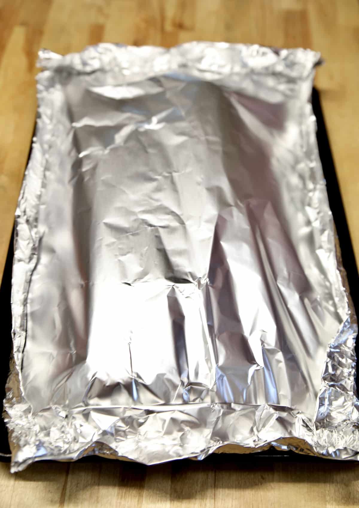 Foil packet of baby back ribs.